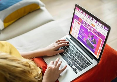 woman visiting an online shopping site with laptop